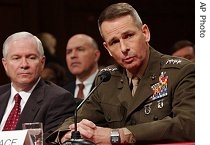 Defense Secretary Robert Gates (l) looks on as Gen. Peter Pace testifies before the Senate Armed Services Committee hearing on Iraq, 12 Jan 2007