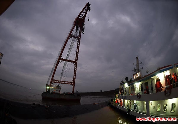 Rescuers work at the site of the overturned passenger ship in the Jianli section of the Yangtze River in central China