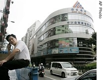 A man talks on a mobile phone in front of the headquarters of Banco a href=