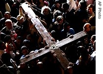 Catholic pilgrims carry a large cross in the Church of the Holy a href=