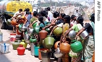 Indians stand in line as they wait to fill containers with drinking water in Hyderabad, 20 a href=