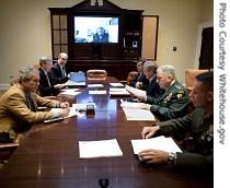 President George W. Bush (left) speaks during a video teleconference with a href=