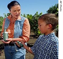 Heidi Kuhn, center, of Roots of Peace, and Kuhn's son, a href=