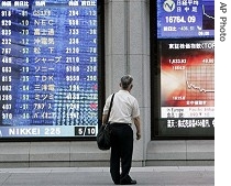 A Japanese businessman looks at a stock a href=