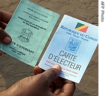 A man shows a student card (L) and a newly-printed election voting card a href=