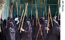 Veiled female students Islamic seminary hold bamboo sticks as they chant slogans during protest, 28 a href=