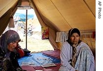 Uzbek women sit in a tent at a a href=