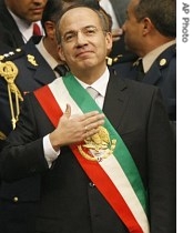 Mexican President Felipe Calderon touches his heart after being sworn in at the National Congress during his a href=