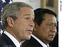 George W. Bush, left, speaks during a a href=