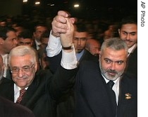 Palestinian Authority President Mahmoud Abbas, left, and Prime Minister Ismail Haniyeh from Hamas, right, raise their linked arms as they move through the crowd at a special session of parliament in Gaza City 17 a href=