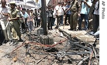 Security personnel push back  crowd gathered near site of  explosion, 18 May 2007