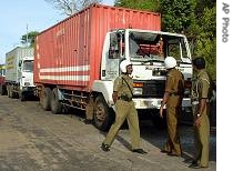 Sri Lankan soldiers inspect a container that was damaged during an a href=