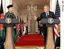 President Bush and Afghanistan's President Hamid Karzai hold a a href=