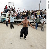 A man gestures as he celebrates with others a href=