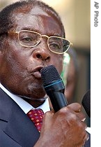 Robert Mugabe addresses supporters at his party's headquarters in Harare, 23 a href=