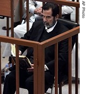 Saddam Hussein reads the Quran as he listens to witness a href=