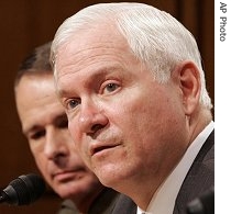 Defense Secretary Robert Gates (r) accompanied by a href=