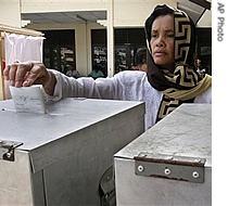 An Acehnese woman casts her a href=