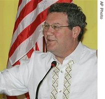 Australian Foreign Minister Alexander Downer gestures as he answers questions from reporters during the 14th ASEAN Regional a href=