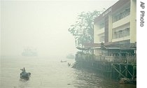 An Indonesian man rows his boat on Kapuas river amid a href=