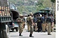 Pakistani troops gather at site of suicide bombing in Matta, a town in Swat mountainous area of Pakistan's Northwest Frontier Province bordering Afghanistan, 15 July 2007 