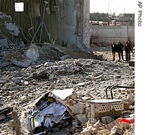 Iraqis look at the destroyed Jameat police station after it was a href=