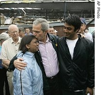 U.S. President Bush (l) comforts residents, as he tours a href=