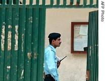 A Pakistani policeman stands inside the Jamia Hifza seminary during a href=