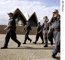 Police patrol the forecourt at the Sydney Opera House as a police helicopter buzzes above as security for APEC a href=