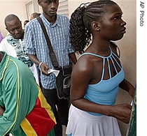 People wait to find out if their visa applications have been approved at the entrance to the French Embassy's visa services office in Dakar, Senegal (File)