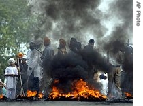 Protesters burn tires during a strike in the a href=