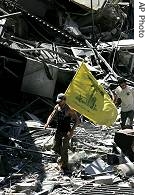 A Hezbollah supporter carries the group's flag as he walks through the a href=