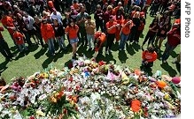 A crowd gathers to observe a moment of silence at Virginia Tech University to remember the victims of the a href=