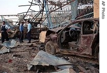 Iraqi police inspect the scene following an explosion in Tal Afar, Nov. 24, 2006