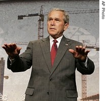 President Bush gestures to the crowd to be seated as he arrives to deliver remarks to the Associated Builders and a href=