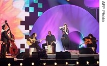 French singer Agnes Jaoui (2ndR) performs after being awarded the Best World Music Album of the Year during the 22nd 