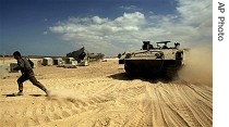 Israeli soldier walks next to armored vehicle at base on border with Gaza Strip, 11 Sep 2007