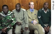 Thomas Cholmondeley sits in courtroom, surrounded by prison a href=