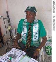 A campaigner works on posters in the paramount chief's office