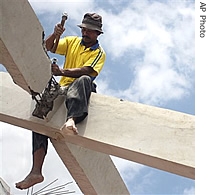 An Indonesian man works on rebuilding a structure in an area a href=