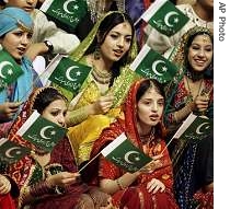 Pakistani girls wave national flags at a flag a href=