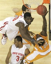 Ohio State's Greg Oden, center, tries to block the shot of Tennessee's Ramar Smith (12) as Dane Bradshaw, top, watches during their NCAA South Regional semifinal, 22 a href=