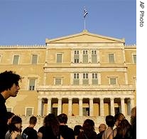 Demonstrators dressed in black stand in front of Parliament house during a protest against the destruction of forests in central Athens, 29 Aug 2007