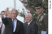 President Bush, left, waves as he leaves the Pentagon, with a href=