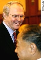 Christopher Hill, left, walks past Chinese Foreign Minister Li Zhaoxing, right, during a meeting in Beijing, 20 Dec. 2006