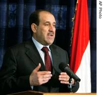 Iraqi PM Nouri al-Maliki talks to the media during a press conference in the heavily a href=