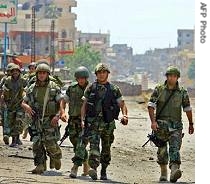 Lebanese special brigades patrol a street inside the Palestinian refugee camp of Nahr al-Bared in north Lebanon, 22 May 2007