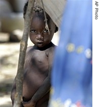 A young refugee child stares from a makeshift camp set up by villagers forced from their home in the latest cycle of a href=