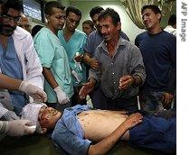 Relatives of Palestinian boy Sohaeb Qdeh, 13, mourn near his body following an Israeli air strike in Abbassan, near Khan Yunis, in the Gaza Strip, early 12 October 2006