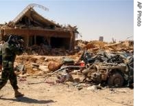 Iraqi soldier videotapes the ruins of a a href=